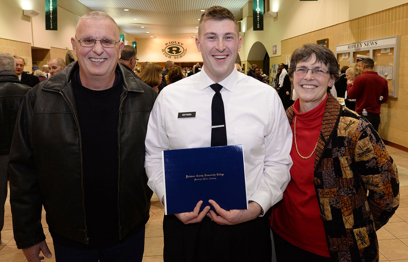 Police Academy graduate with family